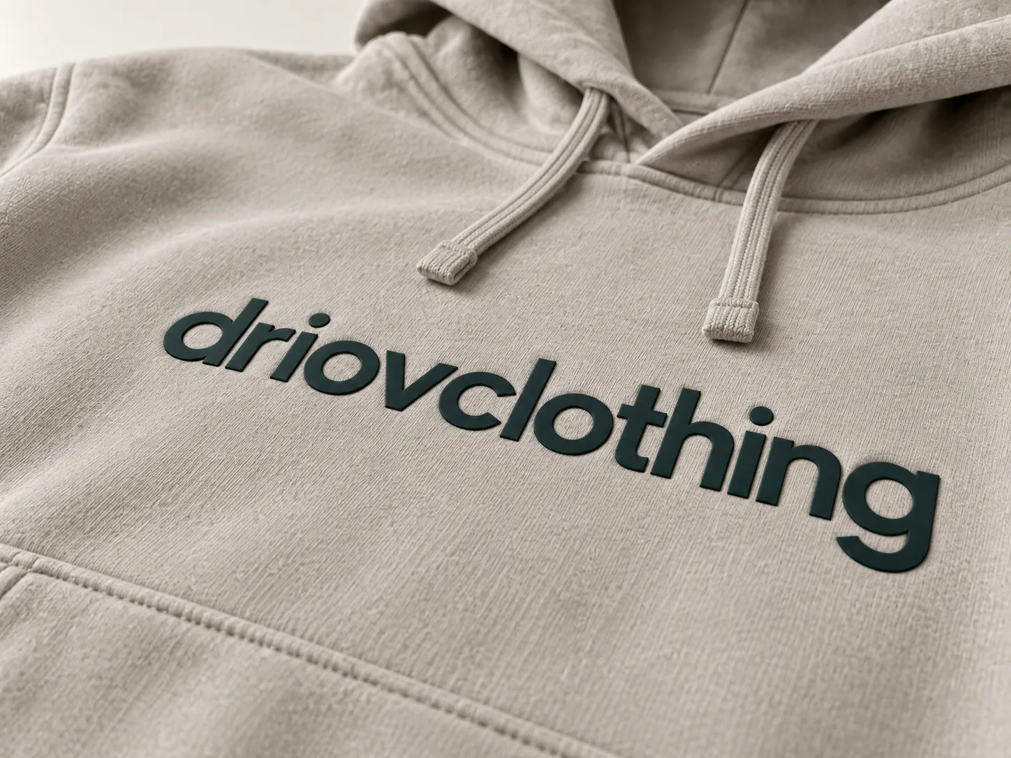 Raised print with defined edges on stone-colored sweatshirt fabric.