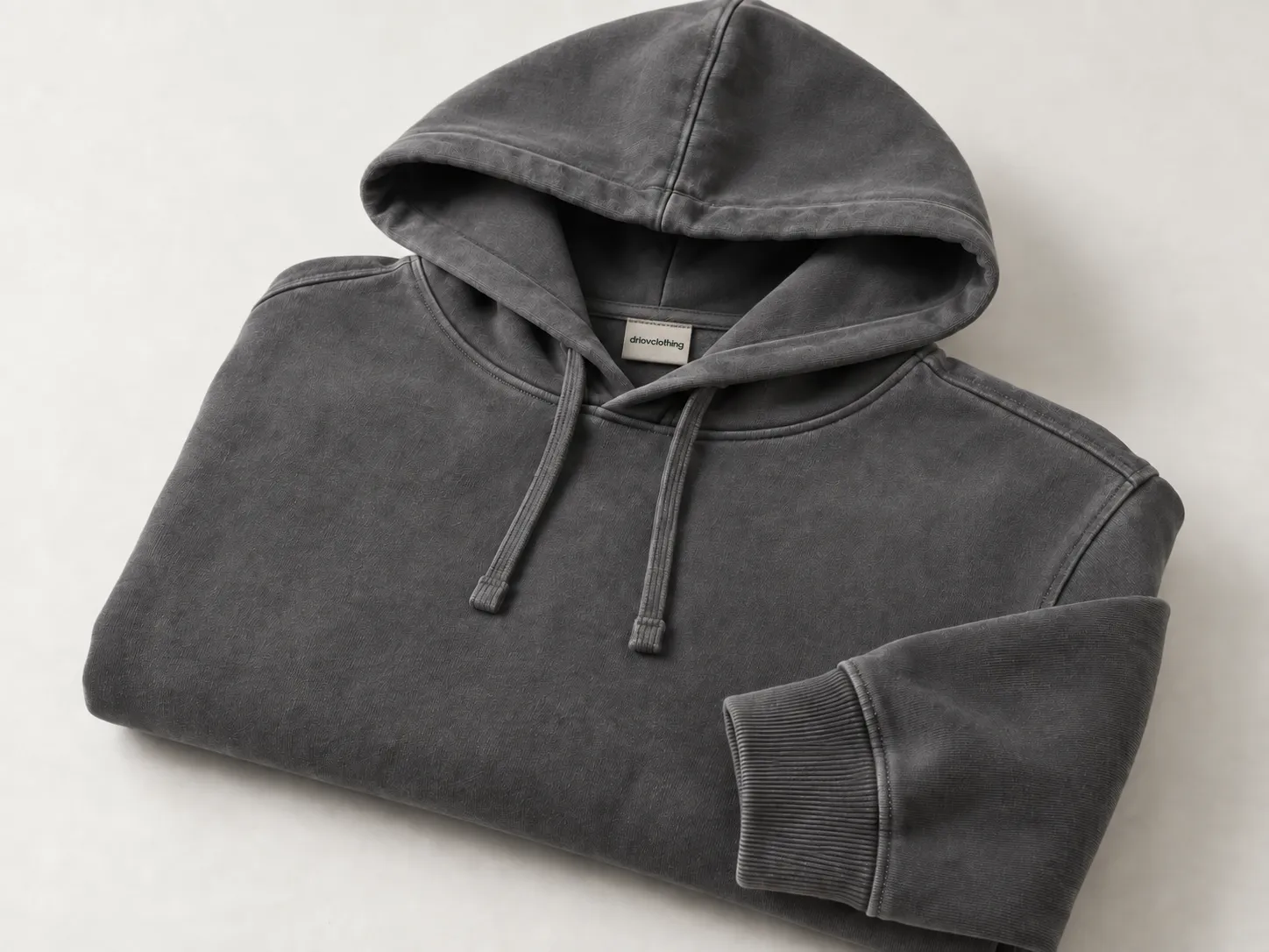 Washed charcoal hoodie with lighter shading around the seams.