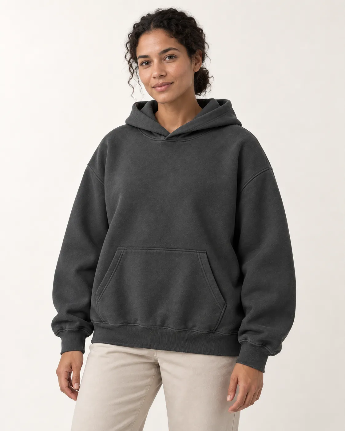 Front view of a model wearing a charcoal pullover hoodie