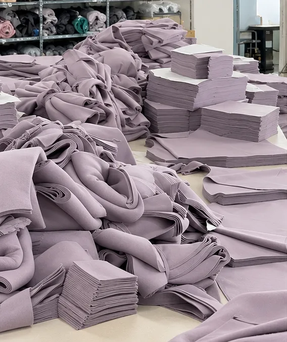 Stacks of purple garment panels after cutting.