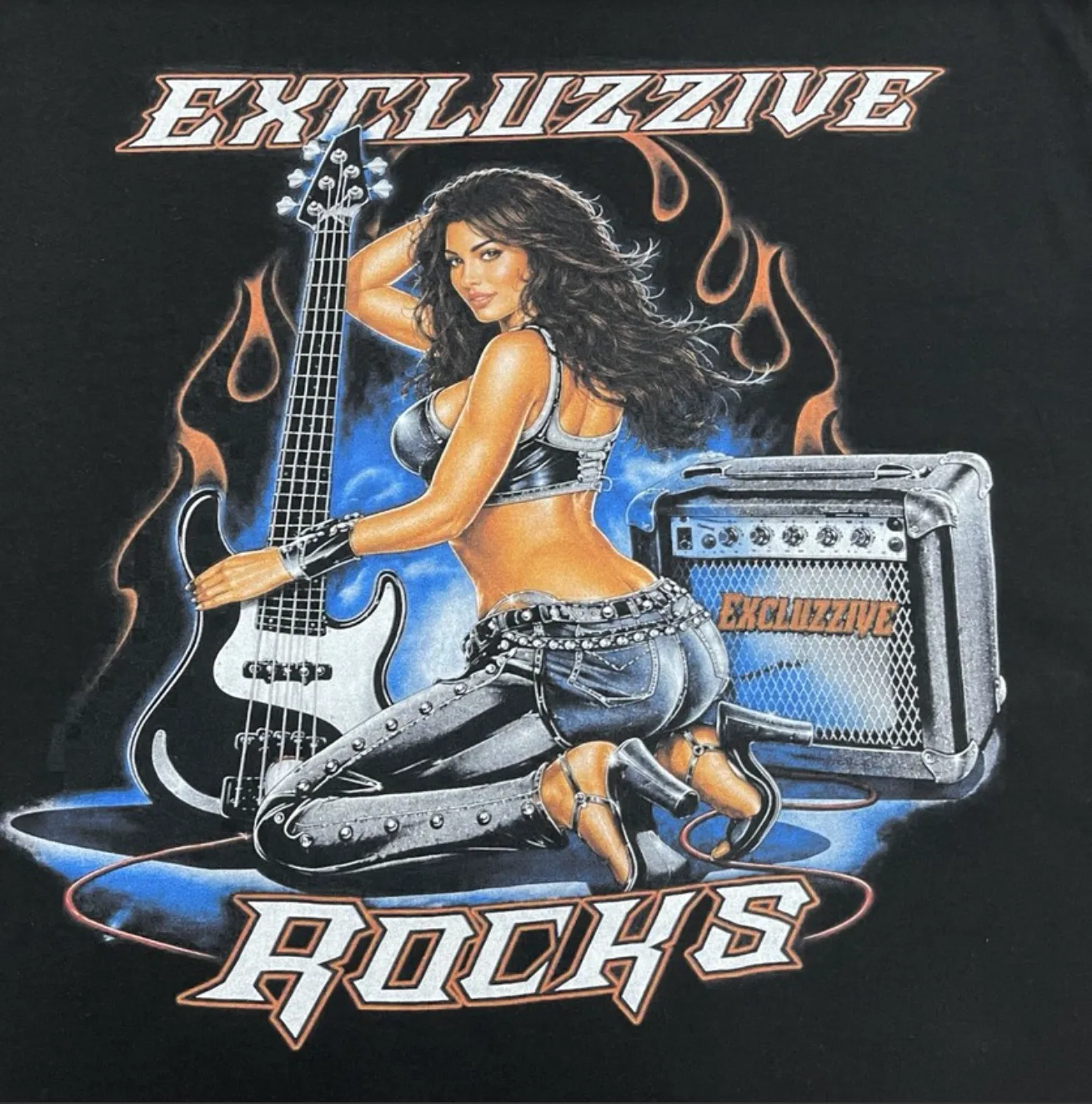 Multicolor print of a guitarist, amplifier and flames on black fabric.