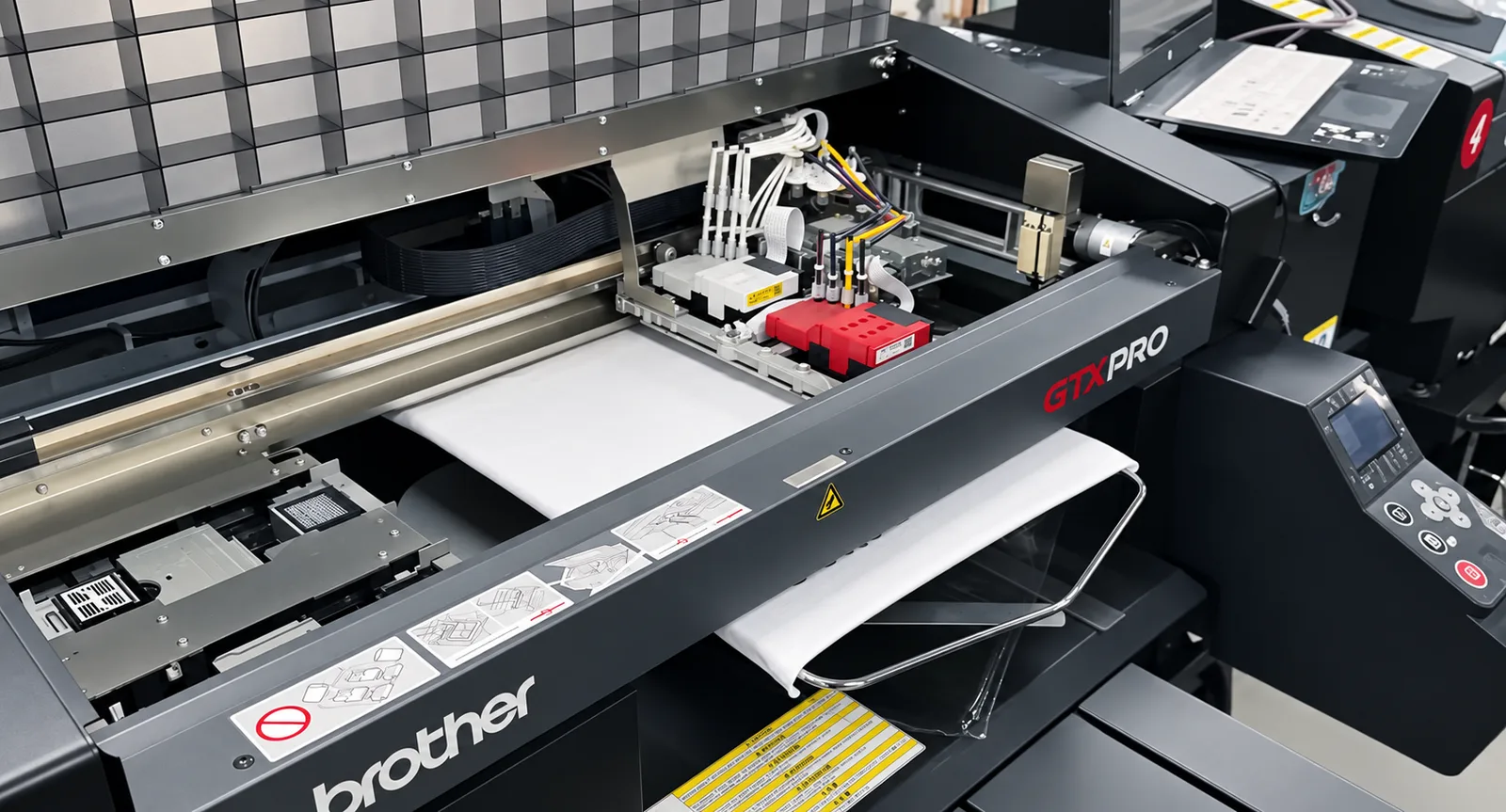 A white garment positioned on the platen of a direct-to-garment printer.