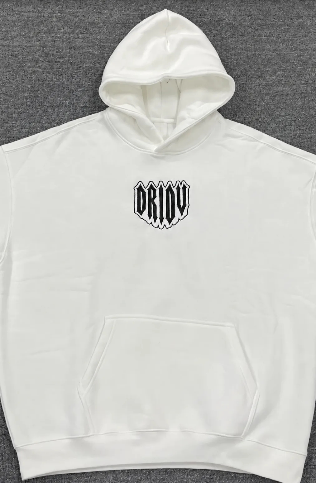 White pullover hoodie with a small black embroidered DRIOV chest emblem.