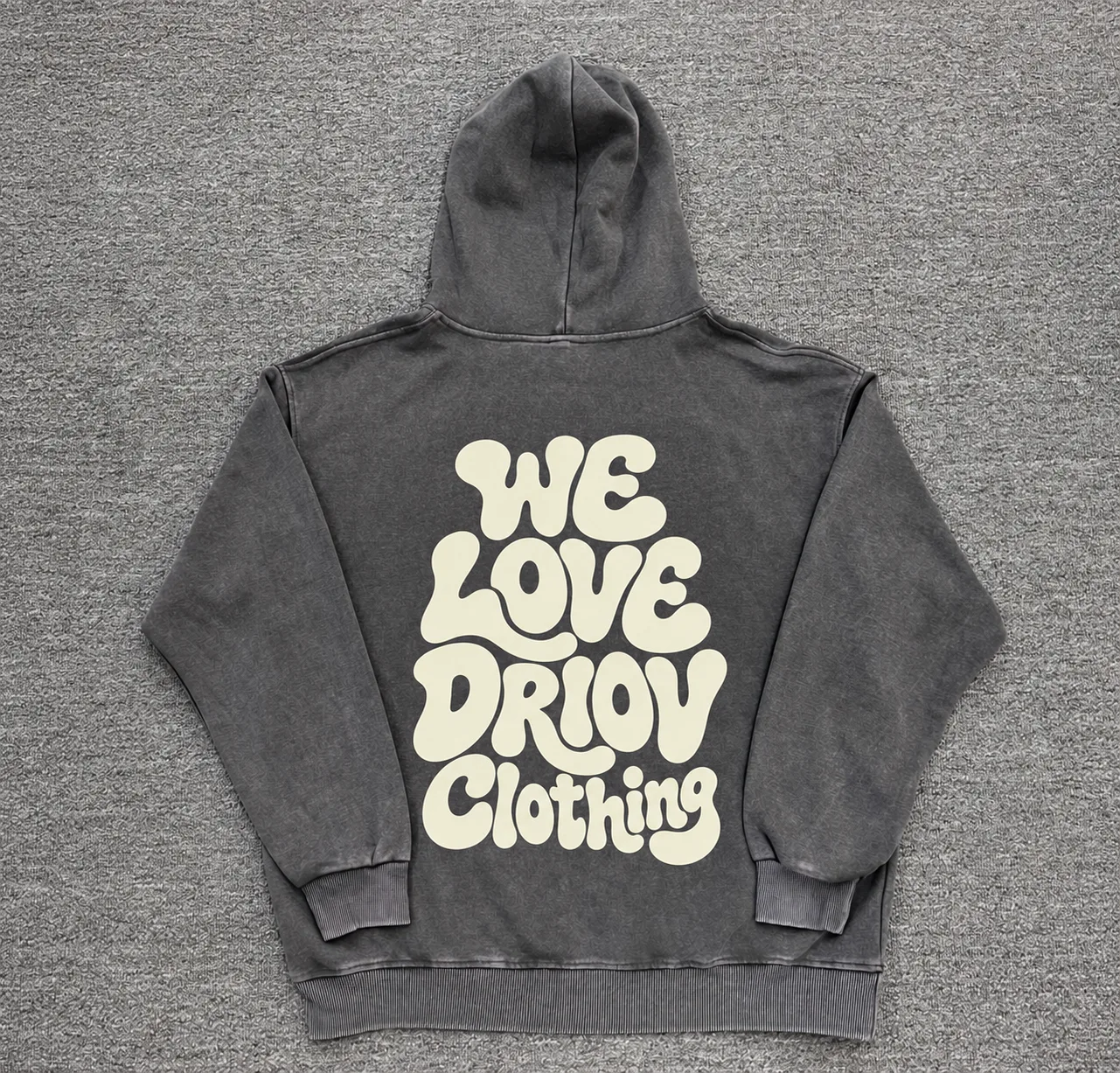 Cream rounded lettering covering the back of a dark grey hoodie.