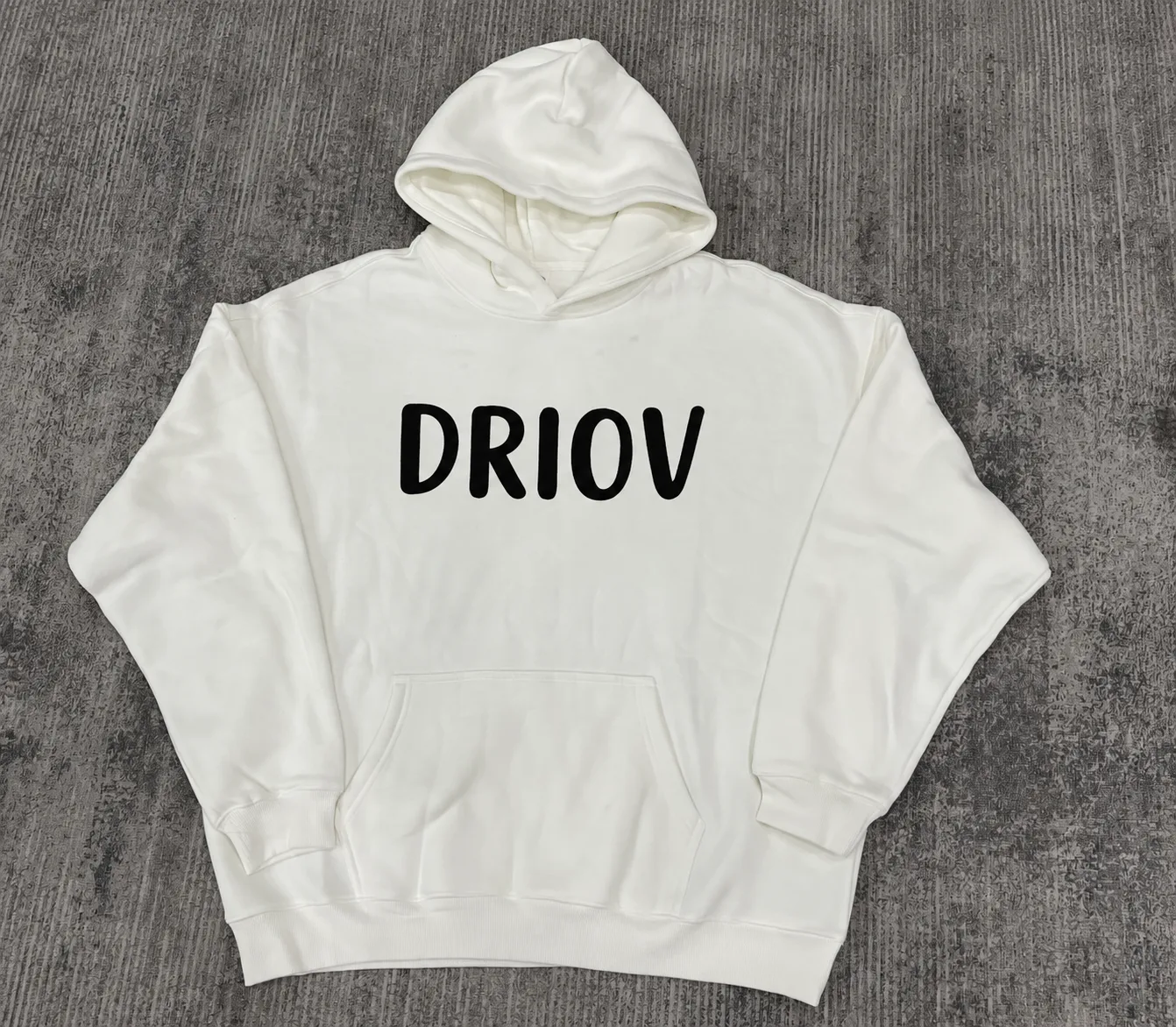 White pullover hoodie with a black DRIOV wordmark across the chest.